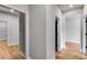 A brightly lit hallway boasts wood-look floors and gray walls with white trim at 8971 Callaway Dr, Winston, GA 30187
