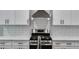 A modern kitchen featuring white cabinets, stainless steel appliances, and a sleek subway tile backsplash at 8971 Callaway Dr, Winston, GA 30187