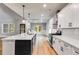 A kitchen featuring white cabinets, stainless steel appliances, an island, and hardwood flooring at 8971 Callaway Dr, Winston, GA 30187