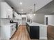 Modern kitchen featuring stainless steel appliances, white cabinets, and a large island with a sink at 8971 Callaway Dr, Winston, GA 30187