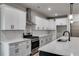 Modern kitchen featuring stainless steel appliances, white cabinets, and a large island with a sink at 8971 Callaway Dr, Winston, GA 30187