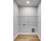 A laundry room features wood-look floors, utility connections, and a white wire storage shelf at 8971 Callaway Dr, Winston, GA 30187