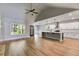 Bright, open-concept living area flowing into the kitchen, featuring hardwood floors at 8971 Callaway Dr, Winston, GA 30187