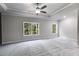 A large main bedroom featuring plush carpets, neutral walls, and two windows for natural light at 8971 Callaway Dr, Winston, GA 30187