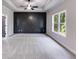 A spacious main bedroom with carpet, an accent wall, tray ceilings, and a ceiling fan at 8971 Callaway Dr, Winston, GA 30187