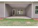 A covered patio features wood-look siding and a concrete base for outdoor entertaining at 8971 Callaway Dr, Winston, GA 30187