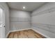 A walk-in closet with built-in shelving and wood-look floors offers efficient storage at 8971 Callaway Dr, Winston, GA 30187