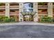 Inviting building entrance with glass doors, landscaped surroundings, and convenient covered drop-off area at 3180 Mathieson Ne Dr # 703, Atlanta, GA 30305