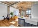 Open-concept living space showcasing kitchen island, exposed brick, and modern furnishings at 3180 Mathieson Ne Dr # 703, Atlanta, GA 30305