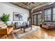 Comfortable living area with exposed brick, natural light, and stylish decor at 3180 Mathieson Ne Dr # 703, Atlanta, GA 30305