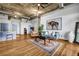 Open living space with hardwood floors, modern furnishings, and exposed ductwork on the ceiling at 3180 Mathieson Ne Dr # 703, Atlanta, GA 30305