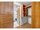 Organized walk-in closet with wooden shelving and drawers near a modern bathroom at 3180 Mathieson Ne Dr # 703, Atlanta, GA 30305