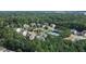 Aerial view of a neighborhood featuring houses, a tennis court, and trees at 520 Andes Ln, Canton, GA 30114