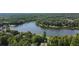 Aerial view of lakefront property with houses and abundant trees at 520 Andes Ln, Canton, GA 30114