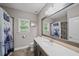 Bathroom with dark vanity, tile shower, and large mirror at 520 Andes Ln, Canton, GA 30114