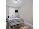 Bright bedroom with neutral walls and metal frame bed at 520 Andes Ln, Canton, GA 30114