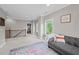 Large bonus room with gray sofa and access to upper hallway at 520 Andes Ln, Canton, GA 30114