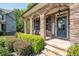 Stone front porch with rocking chairs and landscaping at 520 Andes Ln, Canton, GA 30114