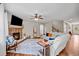 Spacious living room with a cozy stone fireplace and hardwood floors at 520 Andes Ln, Canton, GA 30114