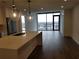 Open living room with hardwood floors, modern kitchen island, and city views at 788 W Marietta Nw St # 805, Atlanta, GA 30318