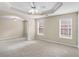 Neutral bedroom featuring an open floor plan, with tray ceilings, neutral carpet and natural light at 202 Meridian Dr, Stockbridge, GA 30281