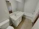 Main bathroom with white vanity, bathtub and tile flooring at 720 Crestwell Sw Cir, Atlanta, GA 30331