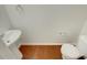 Clean bathroom with pedestal sink, toilet and hardwood floor at 720 Crestwell Sw Cir, Atlanta, GA 30331