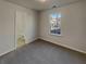 Cozy bedroom featuring grey carpet, a window, and an attached bathroom at 720 Crestwell Sw Cir, Atlanta, GA 30331