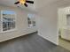 Bright bedroom with grey carpeting, two windows, and en-suite bathroom at 720 Crestwell Sw Cir, Atlanta, GA 30331