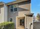 Exterior view of townhouse with tan siding, sliding glass door, and landscaping at 720 Crestwell Sw Cir, Atlanta, GA 30331