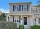 Tan two-story home with black shutters and a covered porch at 720 Crestwell Sw Cir, Atlanta, GA 30331