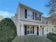 Tan two-story home with black shutters and a covered porch at 720 Crestwell Sw Cir, Atlanta, GA 30331
