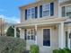 Tan two-story home with black shutters and a covered porch at 720 Crestwell Sw Cir, Atlanta, GA 30331