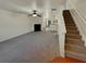 Spacious living room with gray carpet, fireplace, and staircase at 720 Crestwell Sw Cir, Atlanta, GA 30331