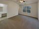 Main bedroom with a large window, carpet, and access to bathroom at 720 Crestwell Sw Cir, Atlanta, GA 30331