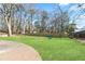 Grassy backyard with mature trees and play structure at 2365 Colleen Sw Cir, Marietta, GA 30060