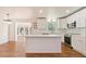 Stylish kitchen featuring white cabinets, stainless steel appliances, a central island, and hardwood floors at 2365 Colleen Sw Cir, Marietta, GA 30060