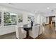 Modern dining room with dark wood table and light beige chairs at 436 Valley Brook Ne Dr, Atlanta, GA 30342