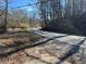 Asphalt road winds through wooded area, showing a peaceful setting at 5571 Shadburn Ferry Rd, Buford, GA 30518