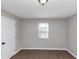 Simple bedroom with wood floors and a window with blinds at 2343 Carver Nw Dr, Atlanta, GA 30314