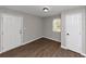 Spacious bedroom with wood floors, window, and double door closet at 2343 Carver Nw Dr, Atlanta, GA 30314