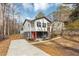 Modern house with gray and white exterior, red door, and a concrete driveway at 2343 Carver Nw Dr, Atlanta, GA 30314