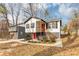 Charming house with gray and white exterior, red door, and stairs leading to a deck at 2343 Carver Nw Dr, Atlanta, GA 30314