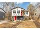 Newly renovated house with gray and white exterior, red door, and a small deck at 2343 Carver Nw Dr, Atlanta, GA 30314