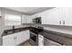 Modern kitchen with white cabinets, stainless steel appliances, and dark granite countertops at 2343 Carver Nw Dr, Atlanta, GA 30314