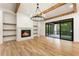 Gathering room with fireplace, built-in shelving, hardwood floors and sliding glass doors leading to a patio at 954 Carl Sanders Dr, Acworth, GA 30101