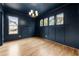 Dark blue office with wainscoting, light hardwood floors, and chandelier at 954 Carl Sanders Dr, Acworth, GA 30101