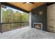 Covered patio with fireplace and wooded views at 954 Carl Sanders Dr, Acworth, GA 30101