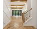 Elegant staircase with wooden railings and herringbone floors at 954 Carl Sanders Dr, Acworth, GA 30101