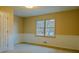 Bedroom with a double window, white wainscoting, a closet, and neutral paint at 110 Fox Meadow Dr, Covington, GA 30016